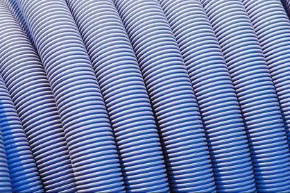 Coiled blue corrugated pump hose